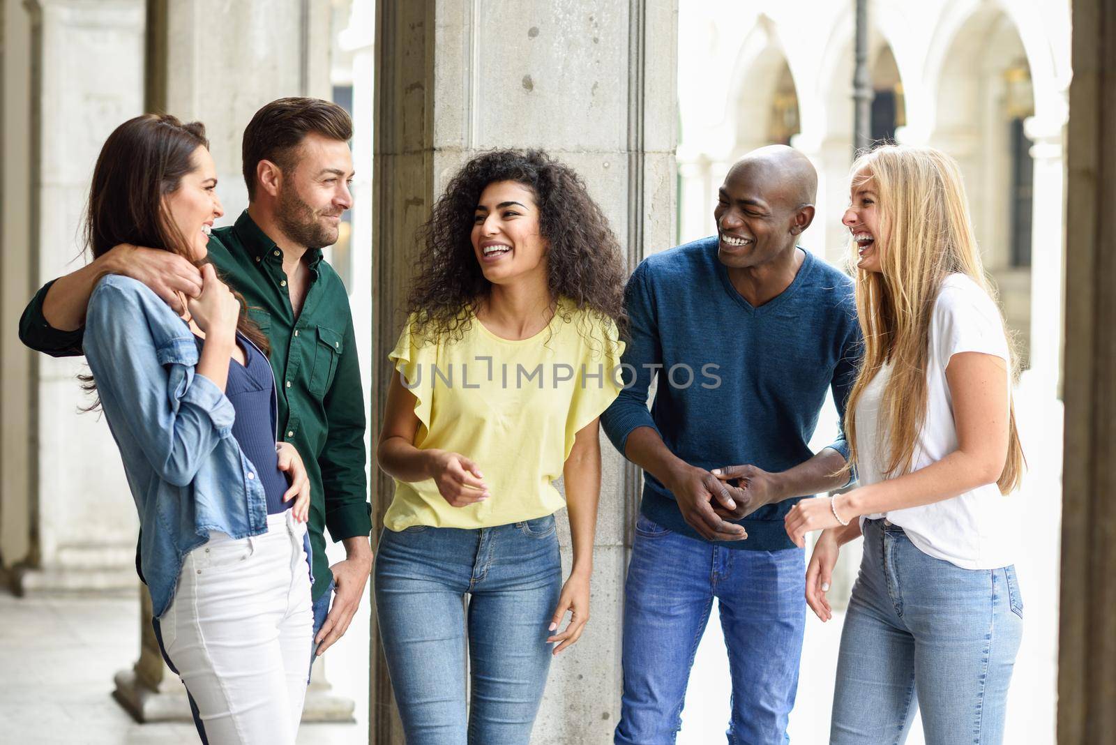 Multi-ethnic group of friends having fun together in urban background by javiindy