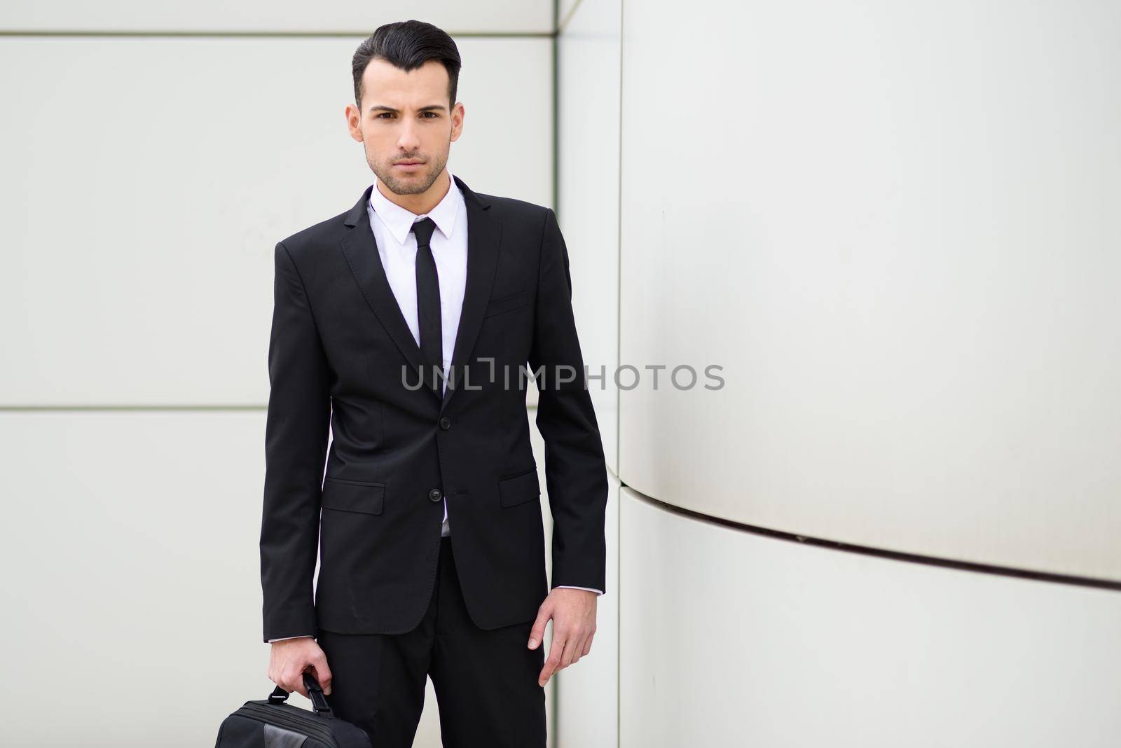 Young businessman near a office building by javiindy