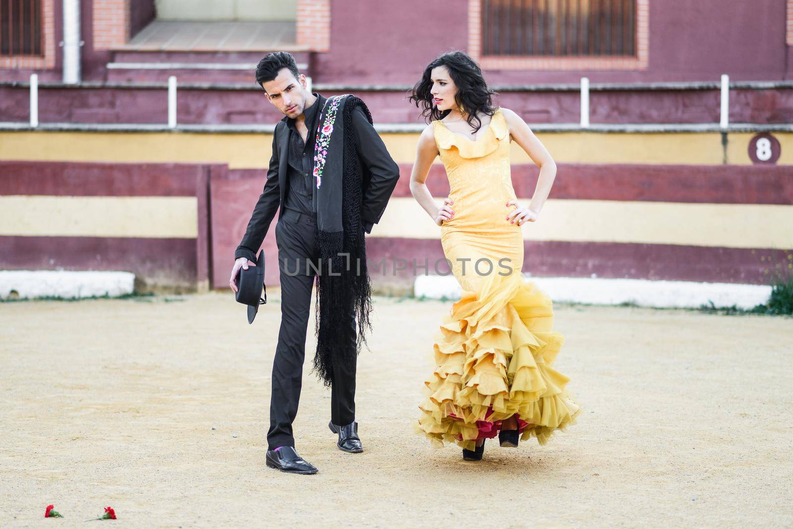 Portrait of a pretty couple, models of fashion, in a bullring. Spanish style