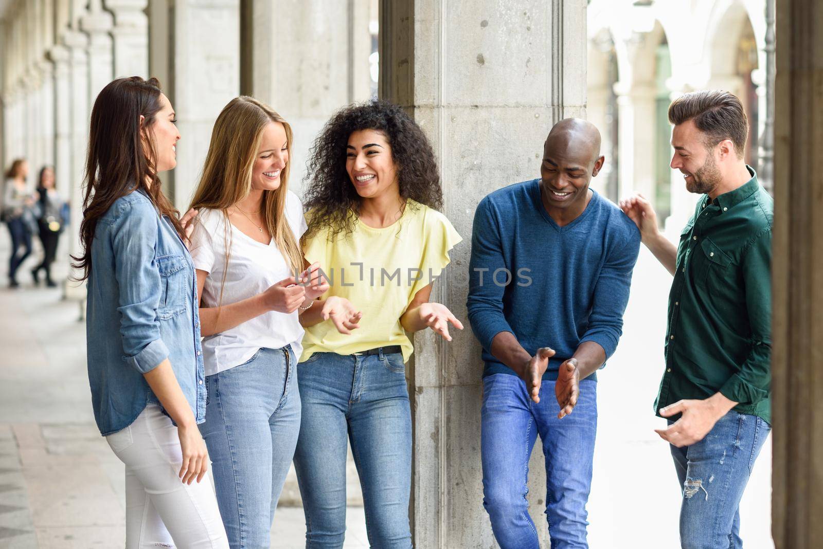 Multi-ethnic group of friends having fun together in urban background by javiindy