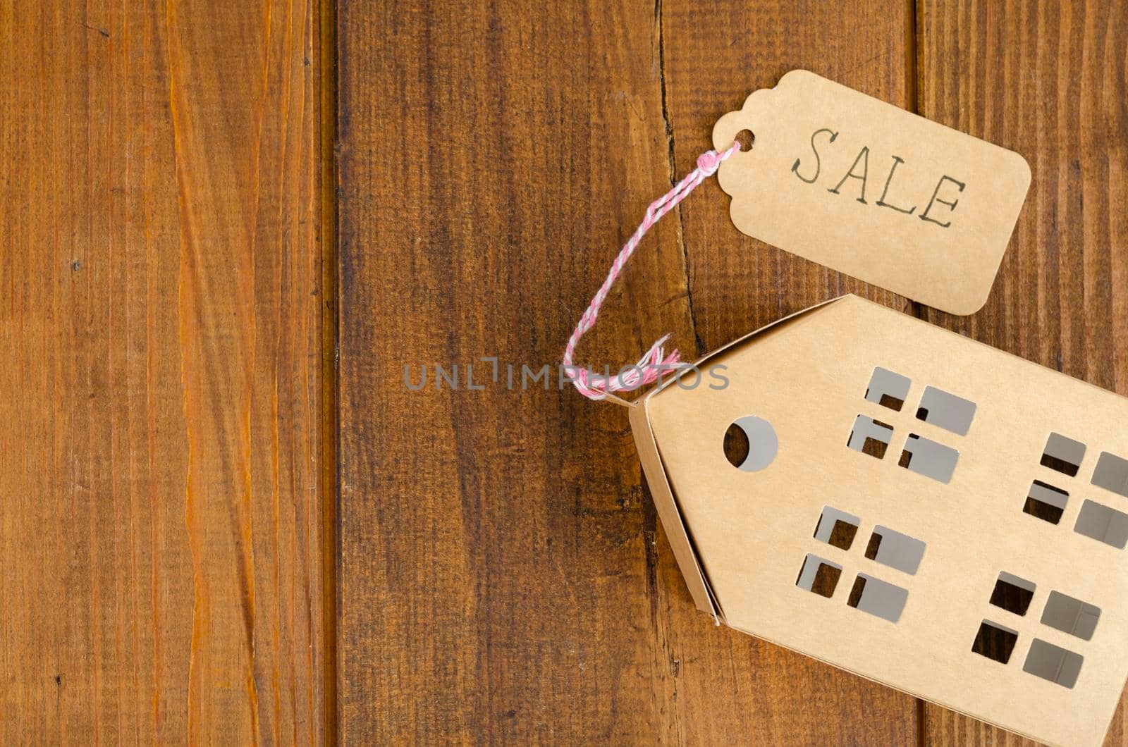 Real estate sale concept, paper model of residential building. Studio Photo