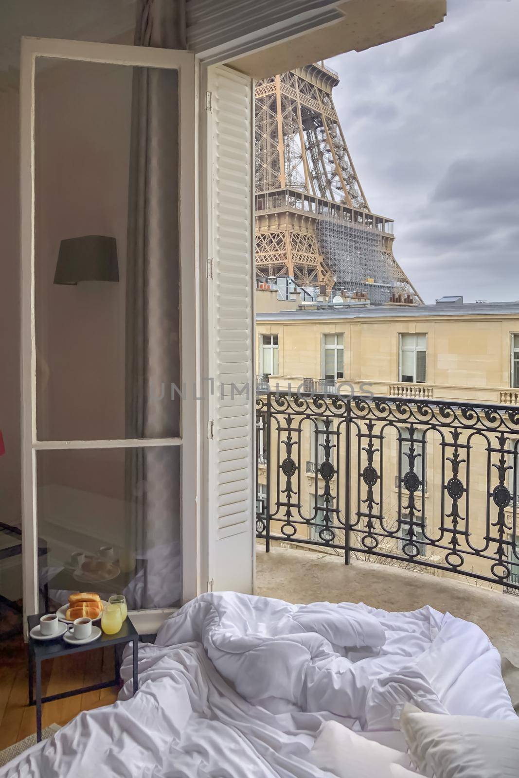 Window view of the Eiffel Tower with breakfast