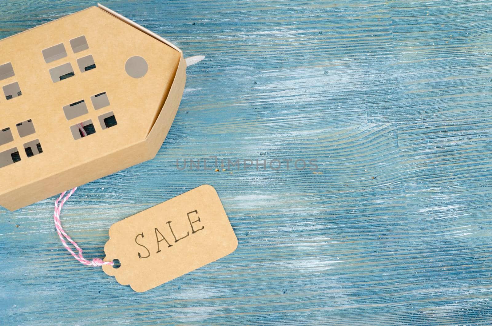 Real estate sale concept, paper model of residential building. Studio Photo
