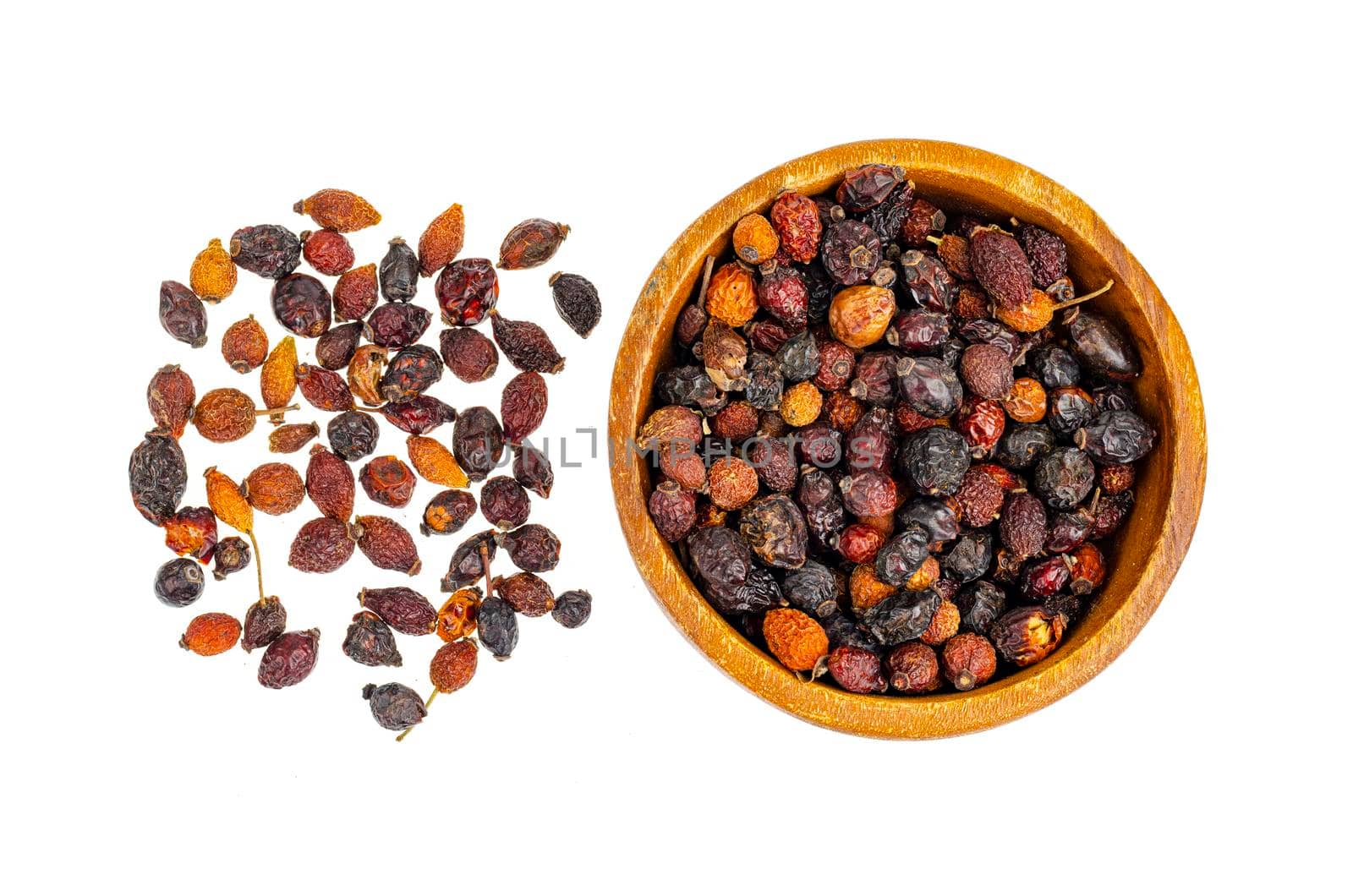 Dried rose hips in wooden bowl, natural vitamin C. Studio Photo