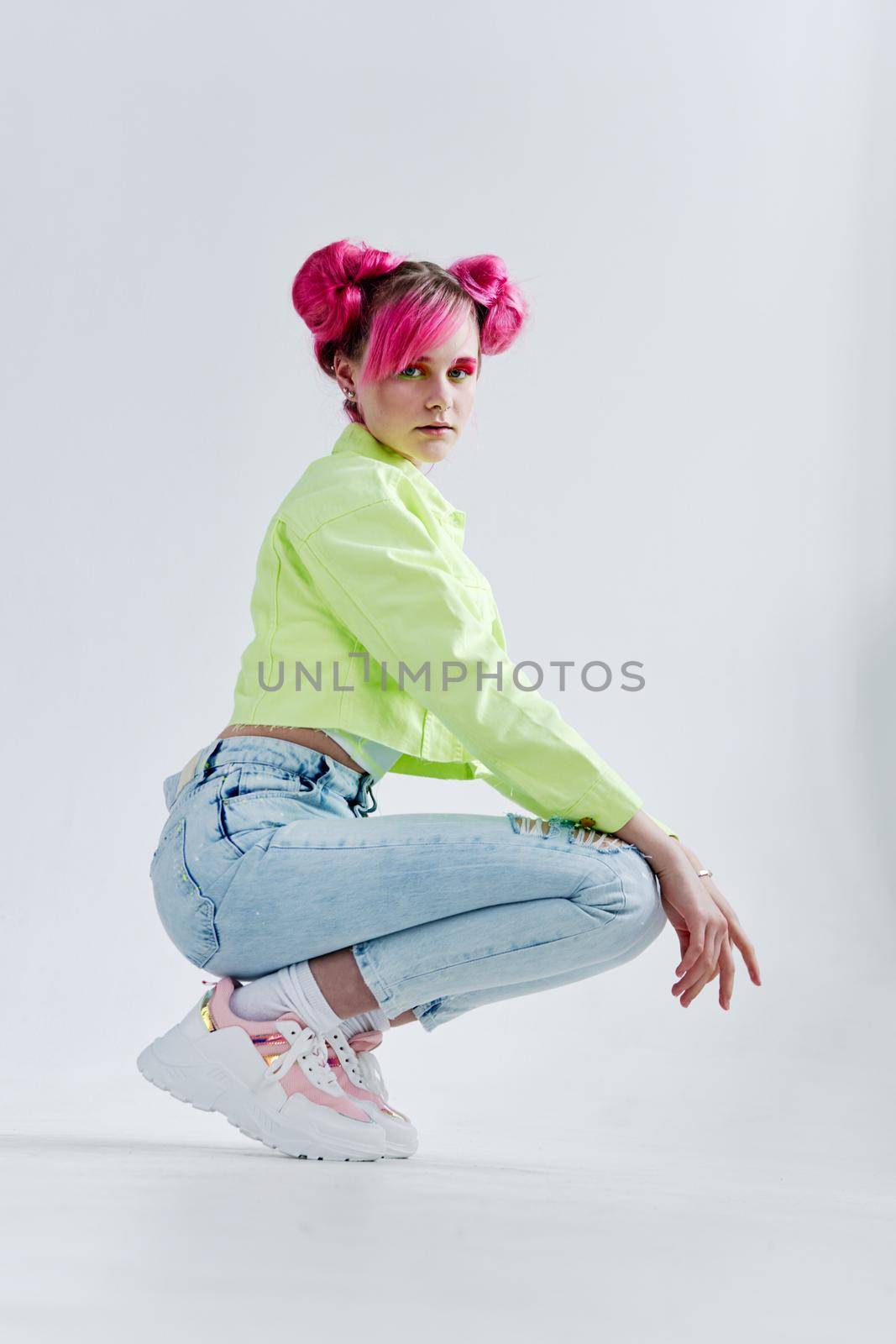 fashionable woman pink hair posing fashion clothes studio model. High quality photo