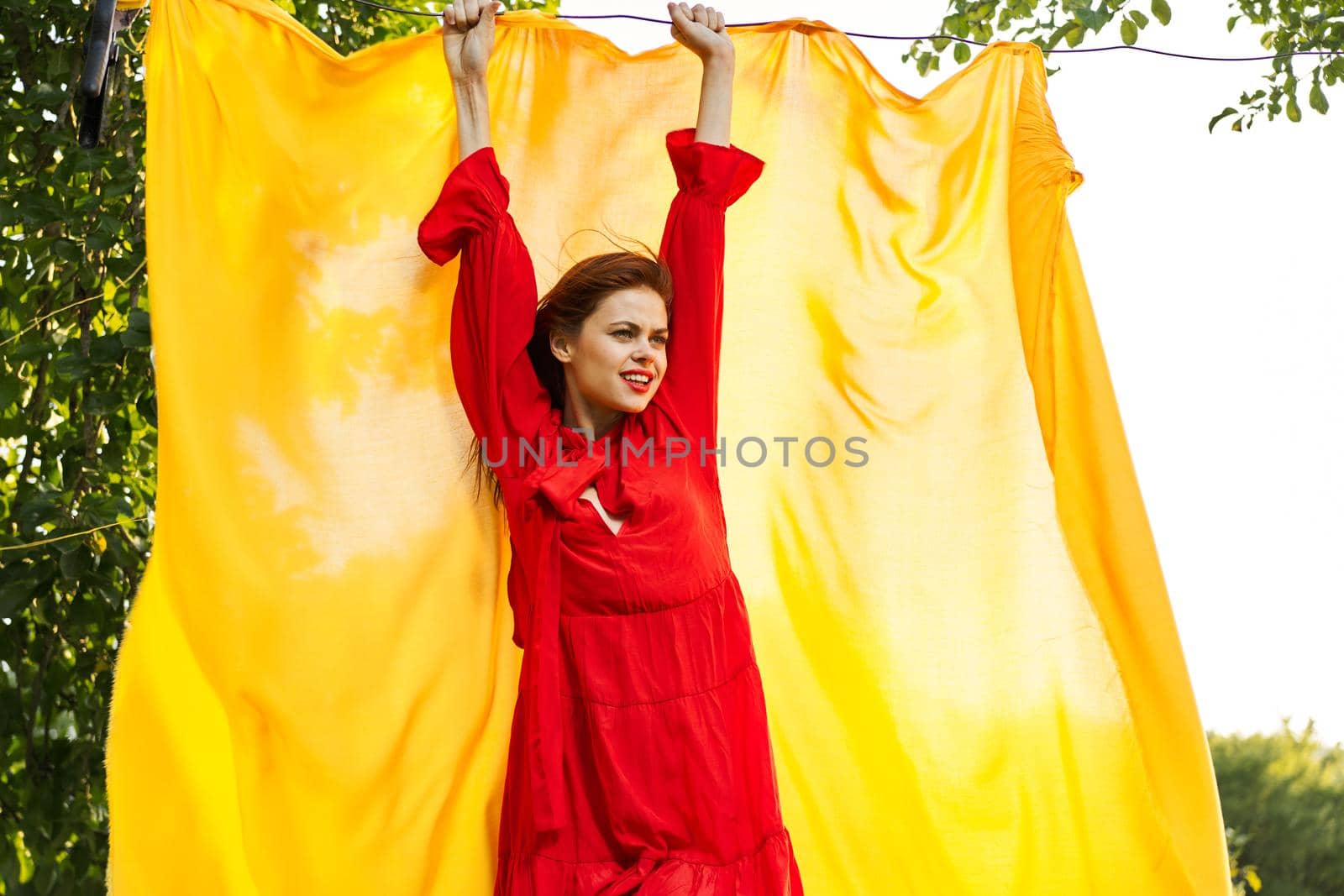 beautiful woman posing in red dress outdoors yellow cloth by Vichizh