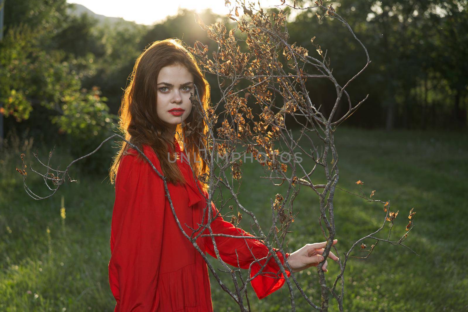 attractive woman in red dress outdoors fresh air summer. High quality photo