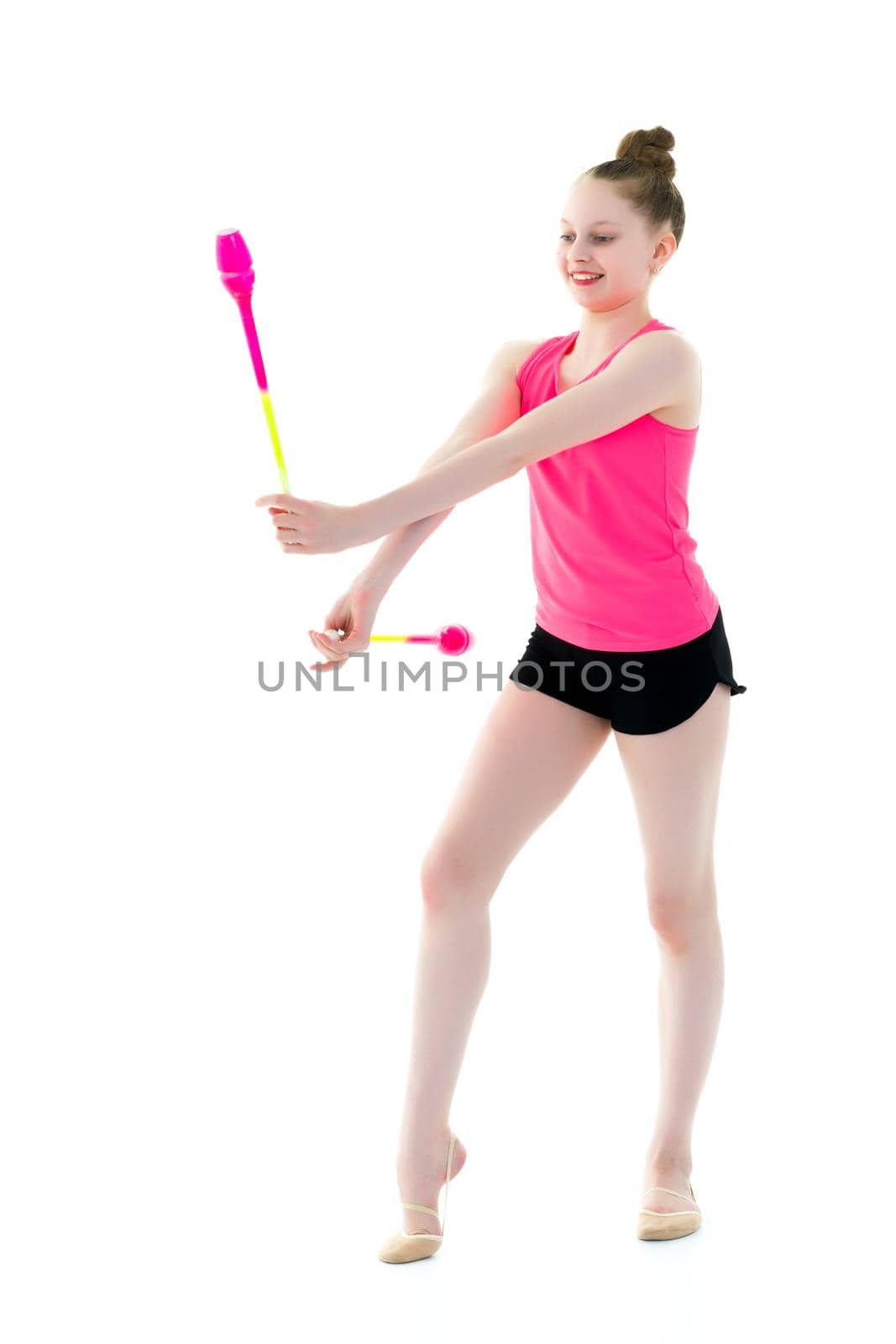 Beautiful little girl gymnast performs exercises with a mace. The concept of children's sports, fitness. Isolated on white background.