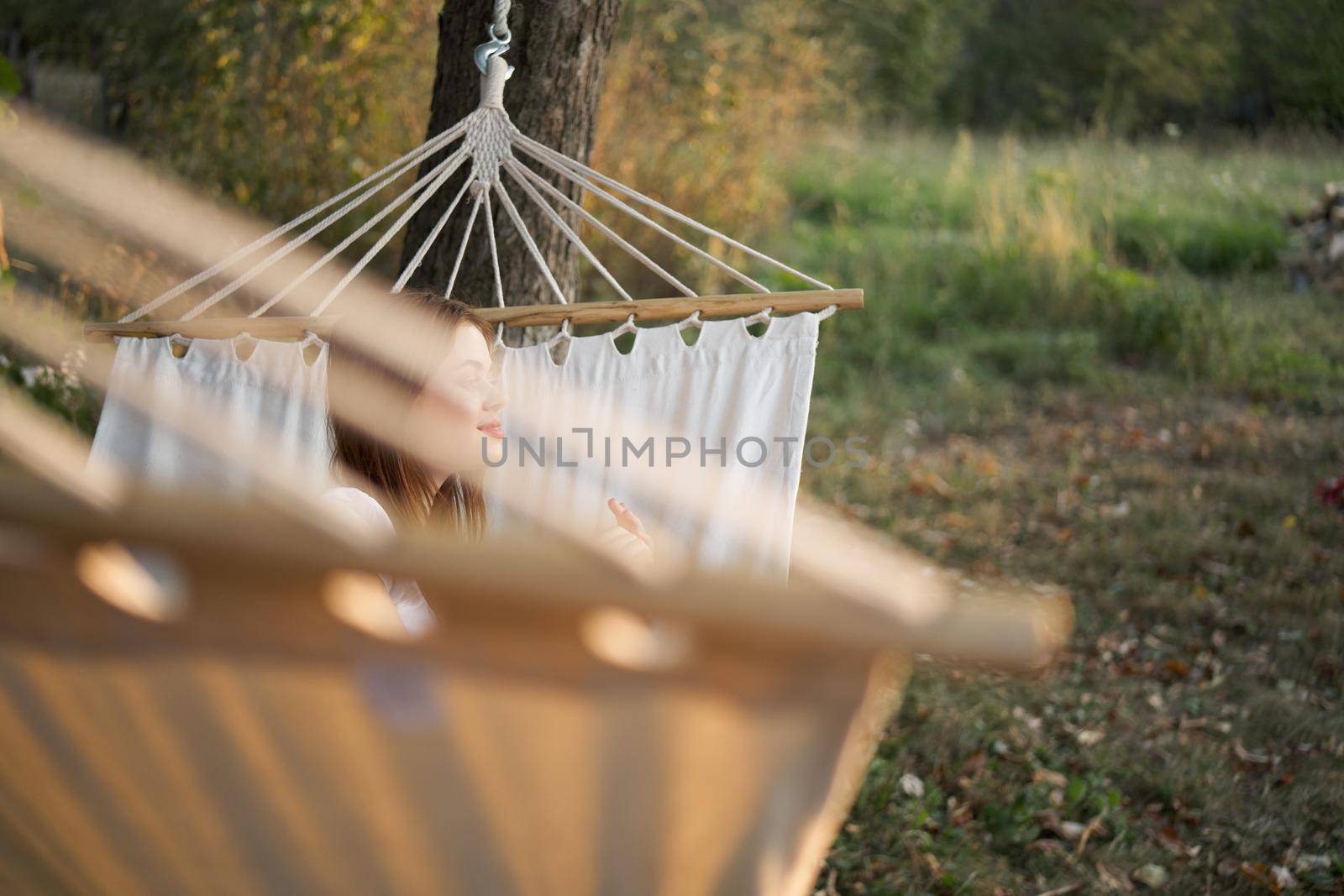 woman relaxing in nature in a hammock garden fresh air by Vichizh