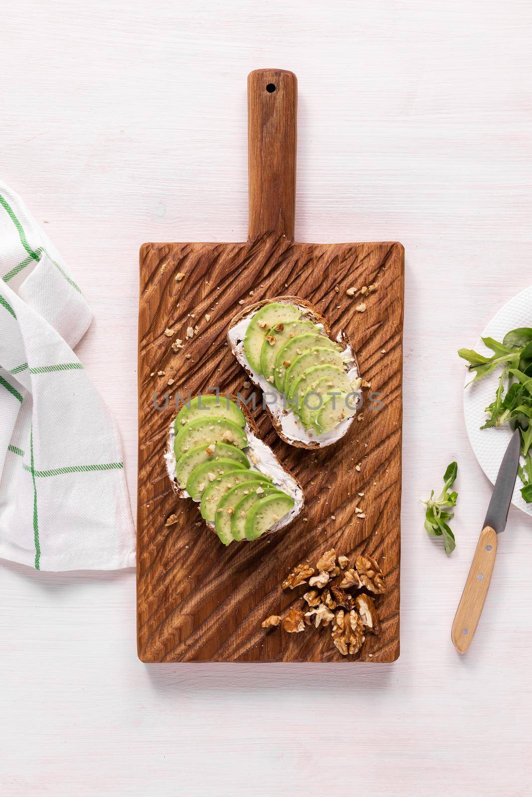 Avocado sandwich on dark rye bread made with fresh sliced avocados from above