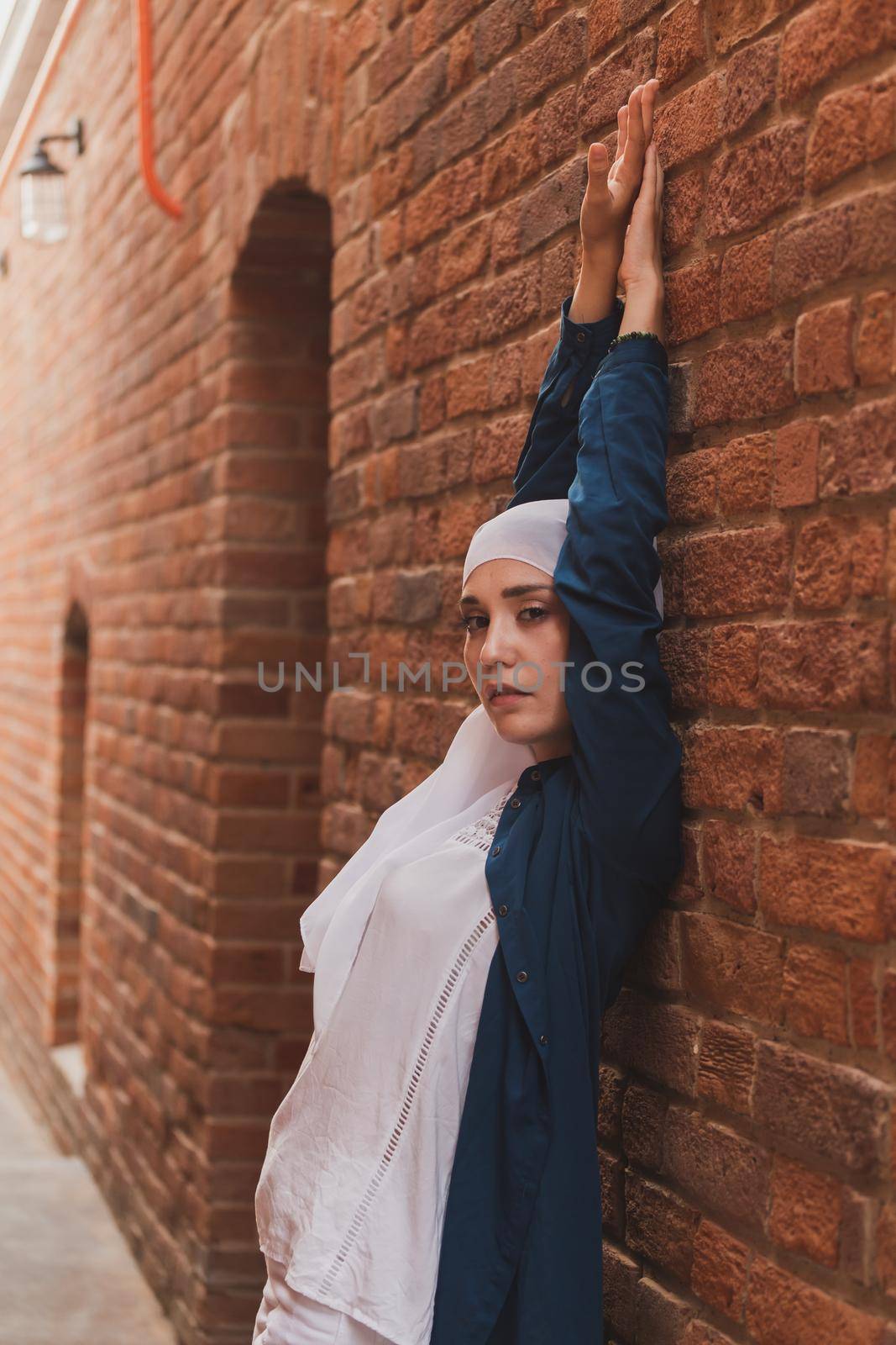 Portrait of female model in fashionable hijab style posing on urban background. Stylish Muslim woman hijab fashion lifestyle portraiture concept
