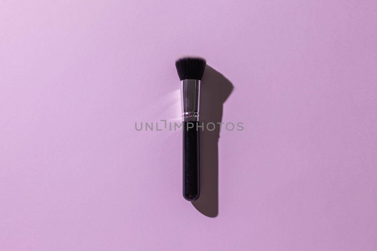 Make-up brush on white background, top view. Cosmetics, beauty and skin care concept