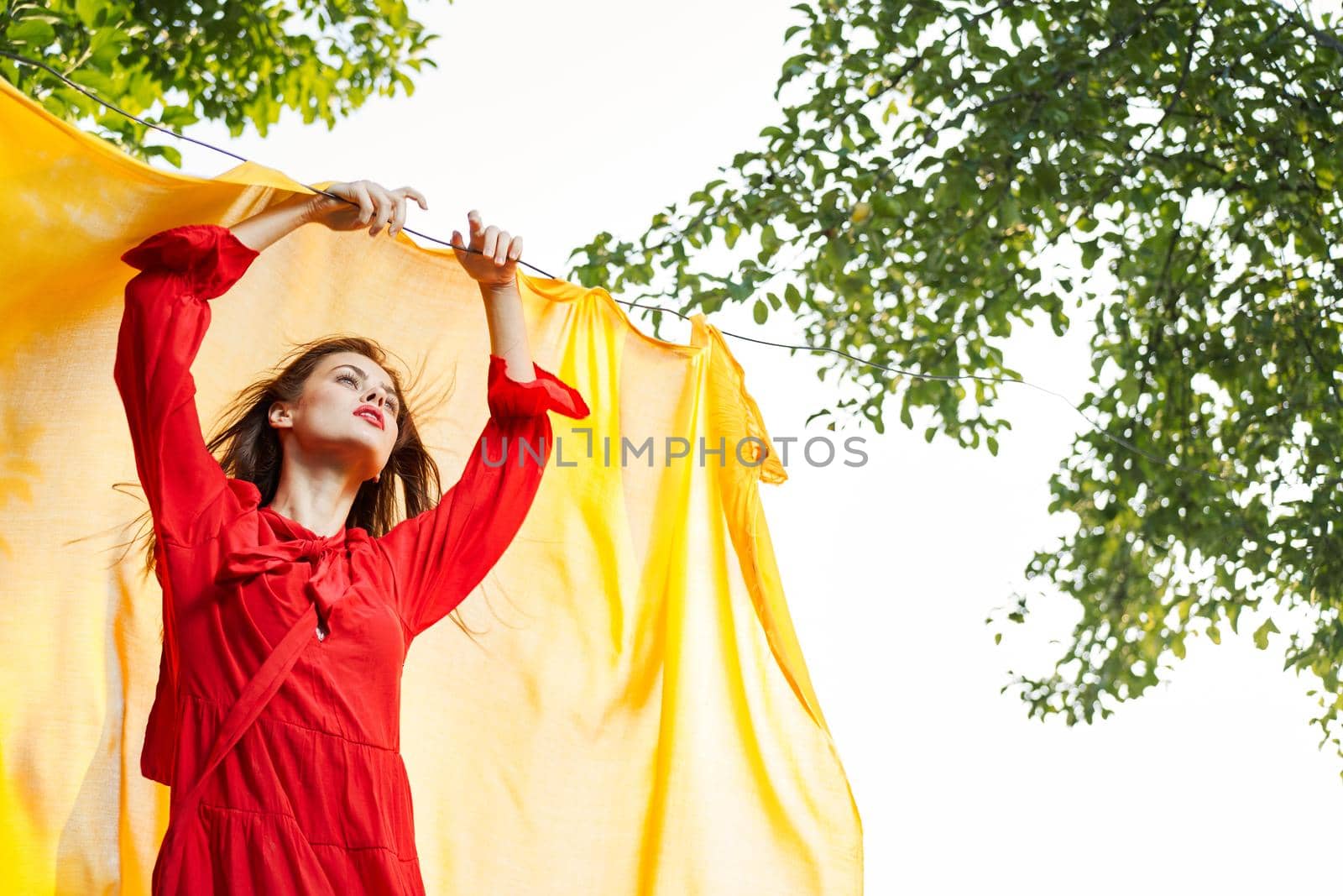 woman in red dress outdoors yellow bedspread by Vichizh