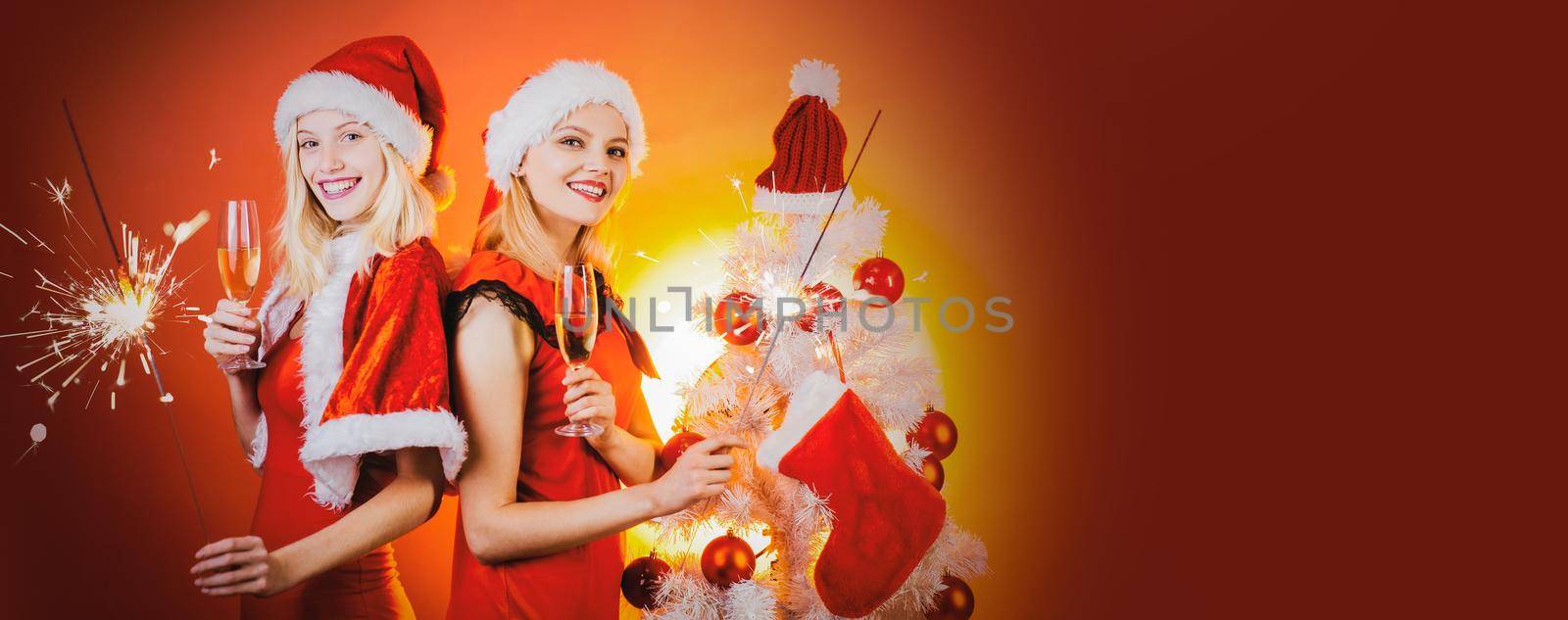 Christmas banner with friends girls. Merry Christmas and Happy Holidays poster. Joyful friends celebrate christmas on red Background