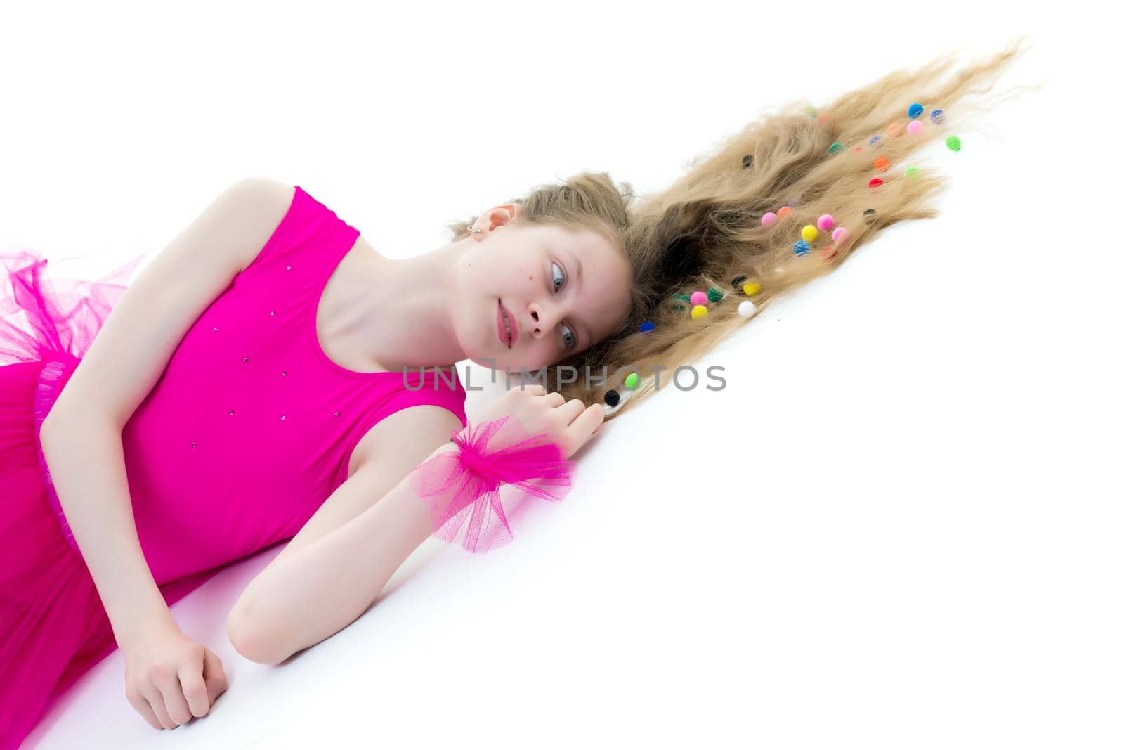 A cute girl gymnast of school age is lying on the floor. by kolesnikov_studio