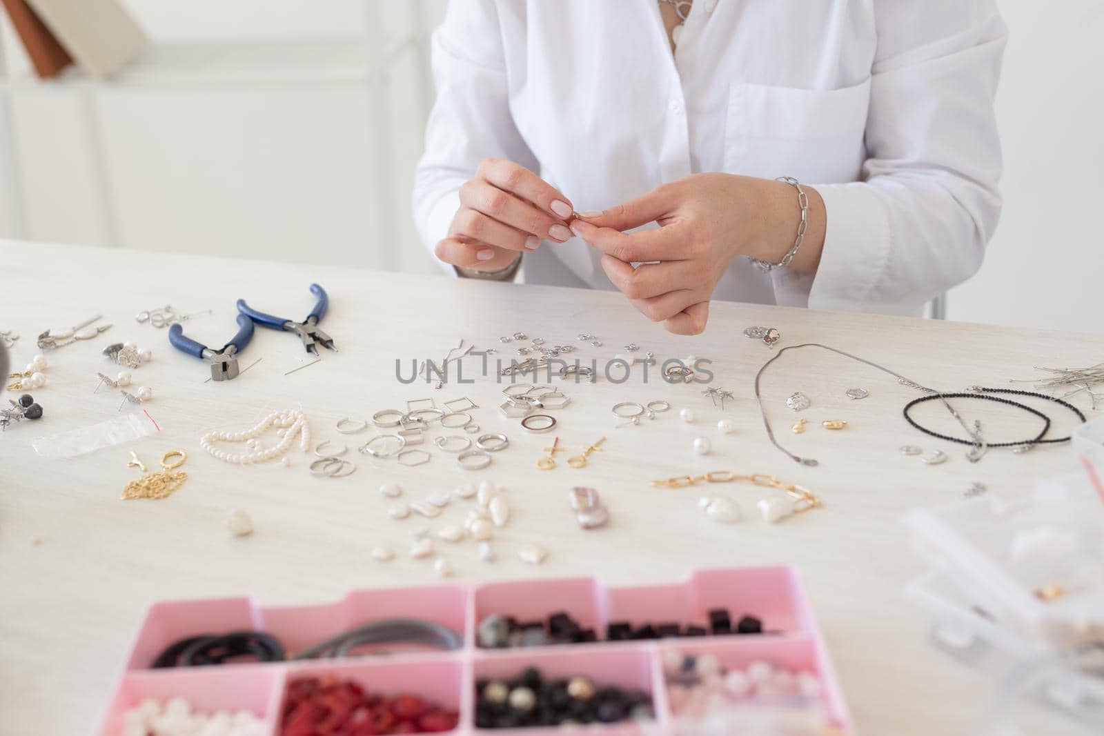 Professional jewelry designer making handmade jewelry in studio workshop close up. Fashion, creativity and handmade concept by Satura86