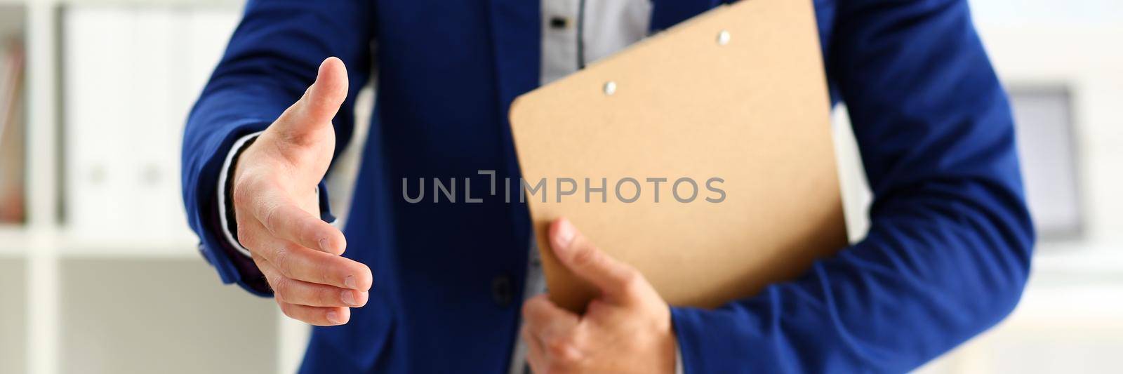 Businessman offer hand to shake as hello in office closeup. Serious business, friendly support service, excellent prospect, introduction or thanks gesture, gratitude, invite to participate concept