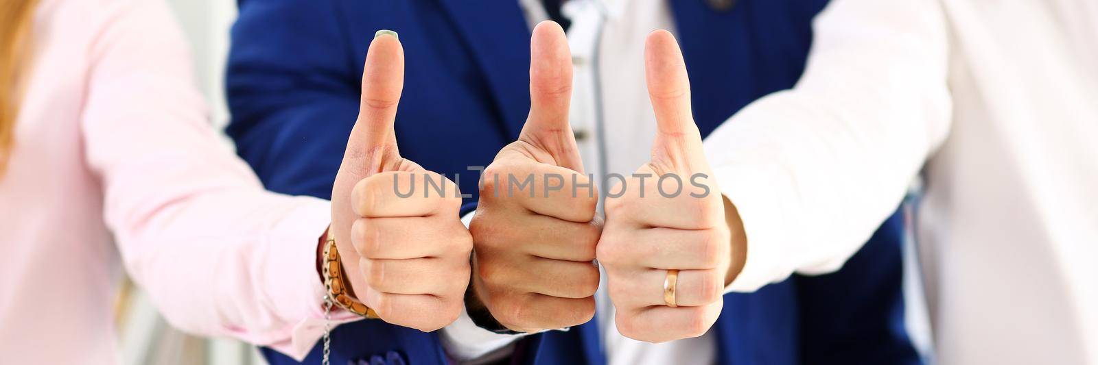 Group of people show OK or approval with thumb up by kuprevich