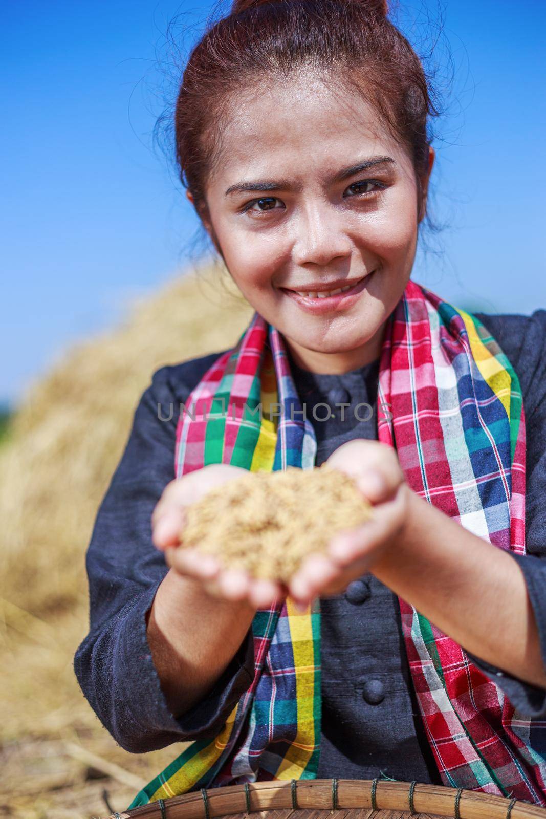 paddy rice in happy farmer woman hand