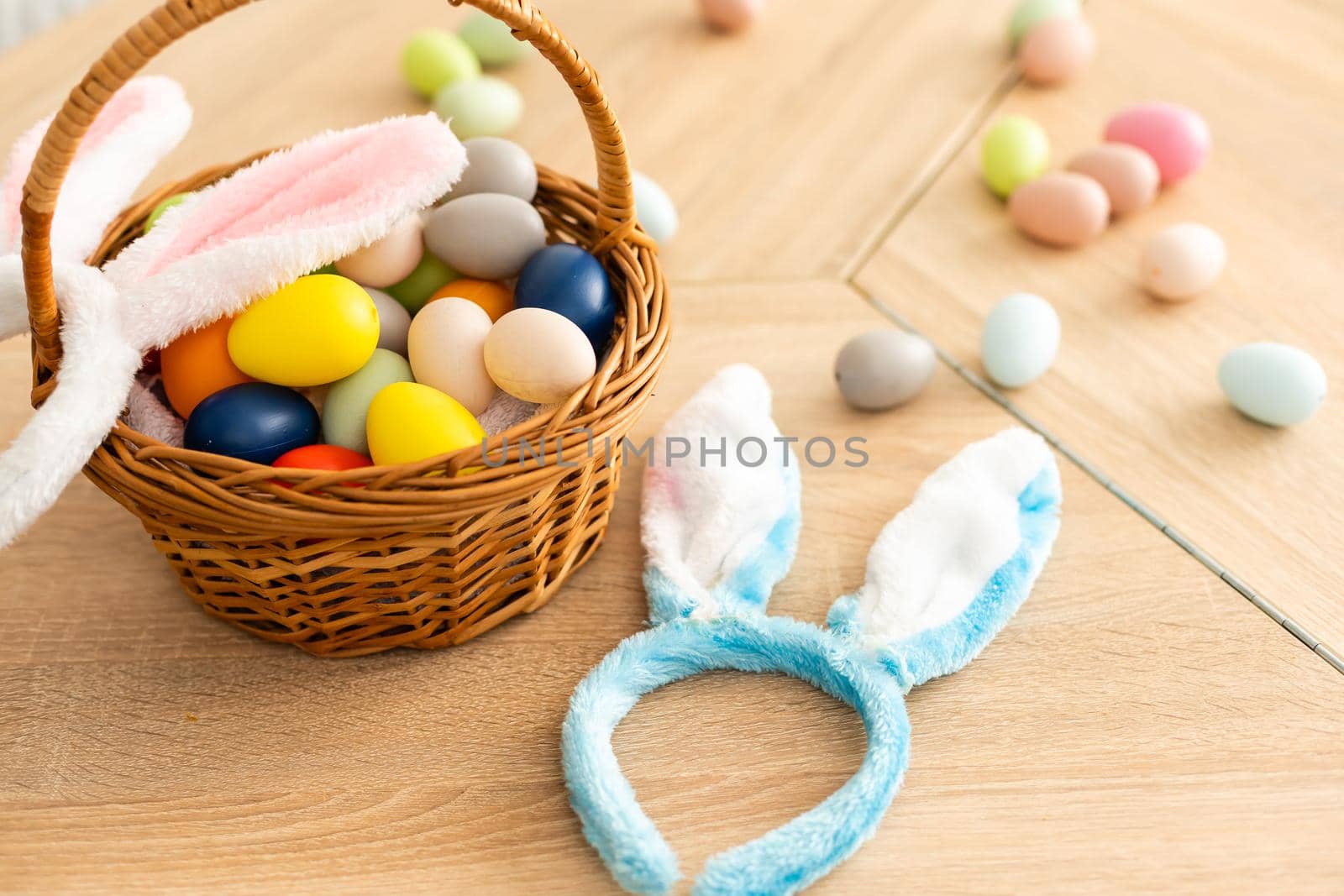 Easter concept. Eggs, Bunny's ears on festive Easter table background top-down copy space.