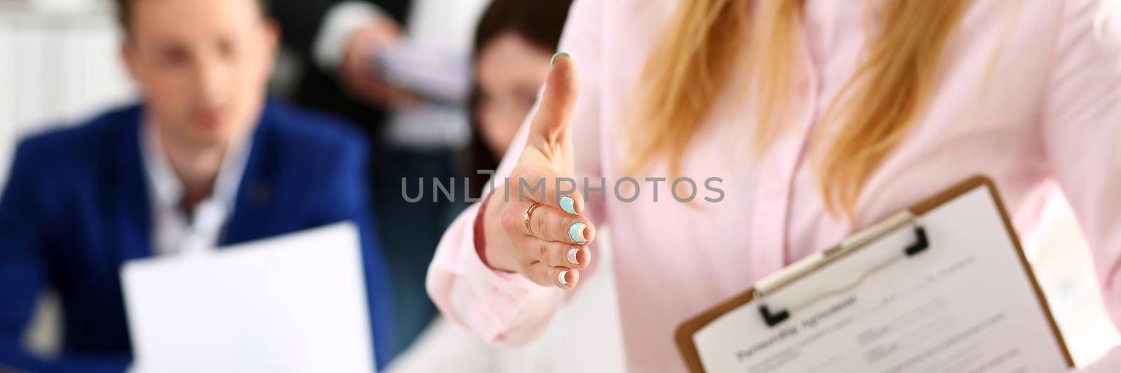 Businesswoman offer hand to shake as hello in office closeup by kuprevich