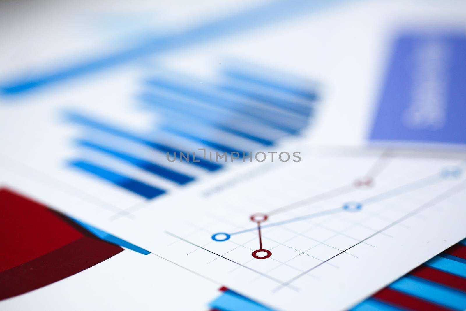 Financial statistics documents on clipboard pad at office table closeup by kuprevich
