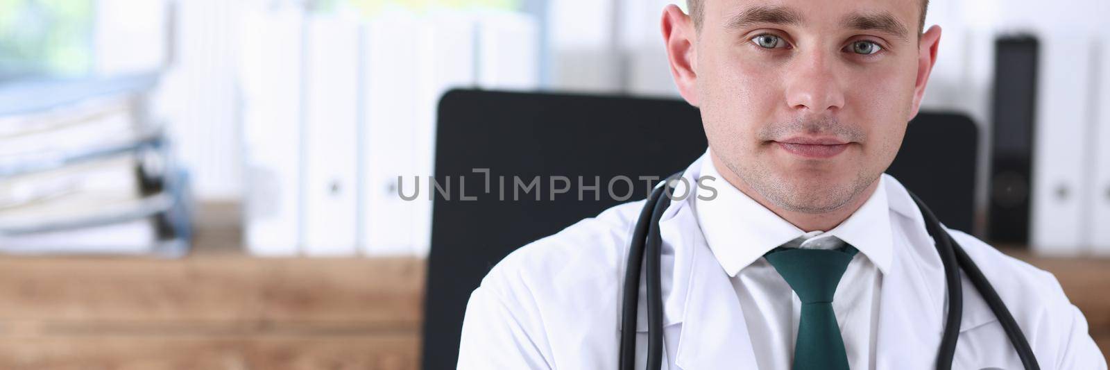 Handsome smiling male doctor stand in office looking in camera portrait. Medic store, physical and patient disease prevention, er consultant, 911, profession, pulse measure, healthy lifestyle concept