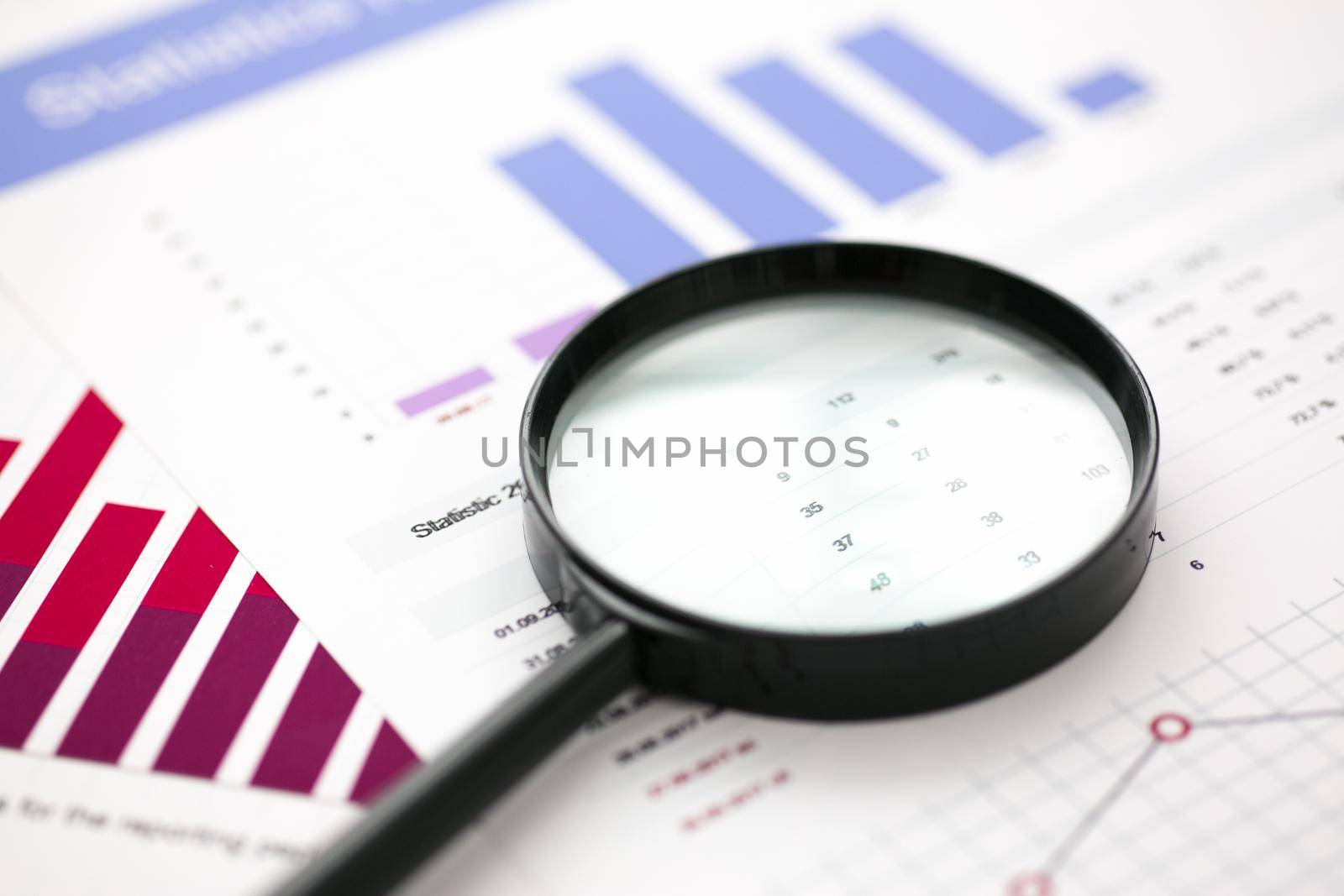 Financial statistics documents with lens at office table closeup. Internal Revenue Service inspector sum check, irs investigation, exchange market, earnings, savings, loan and credit concept