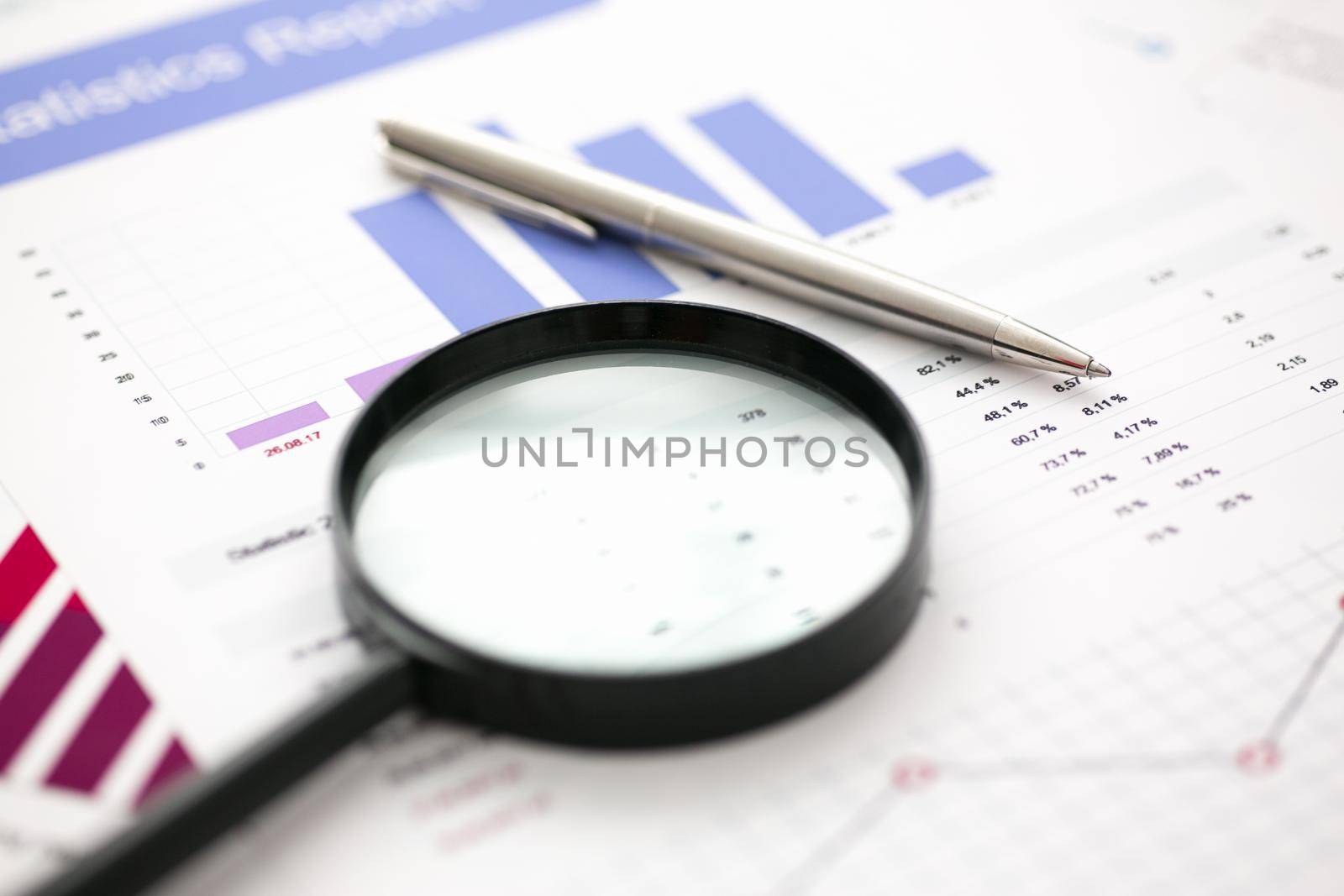 Financial statistics documents on lens and pen office table closeup. Internal Revenue Service inspector sum check, irs investigation, exchange market, earnings, savings, loan and credit concept