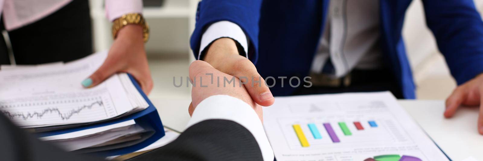 Man in suit shake hand as hello in office closeup by kuprevich