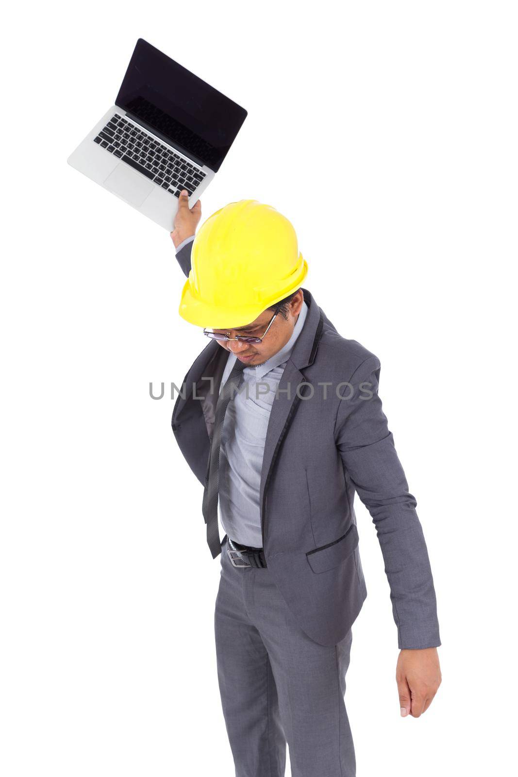 very angry engineer is throwing away his laptop isolated on a white background