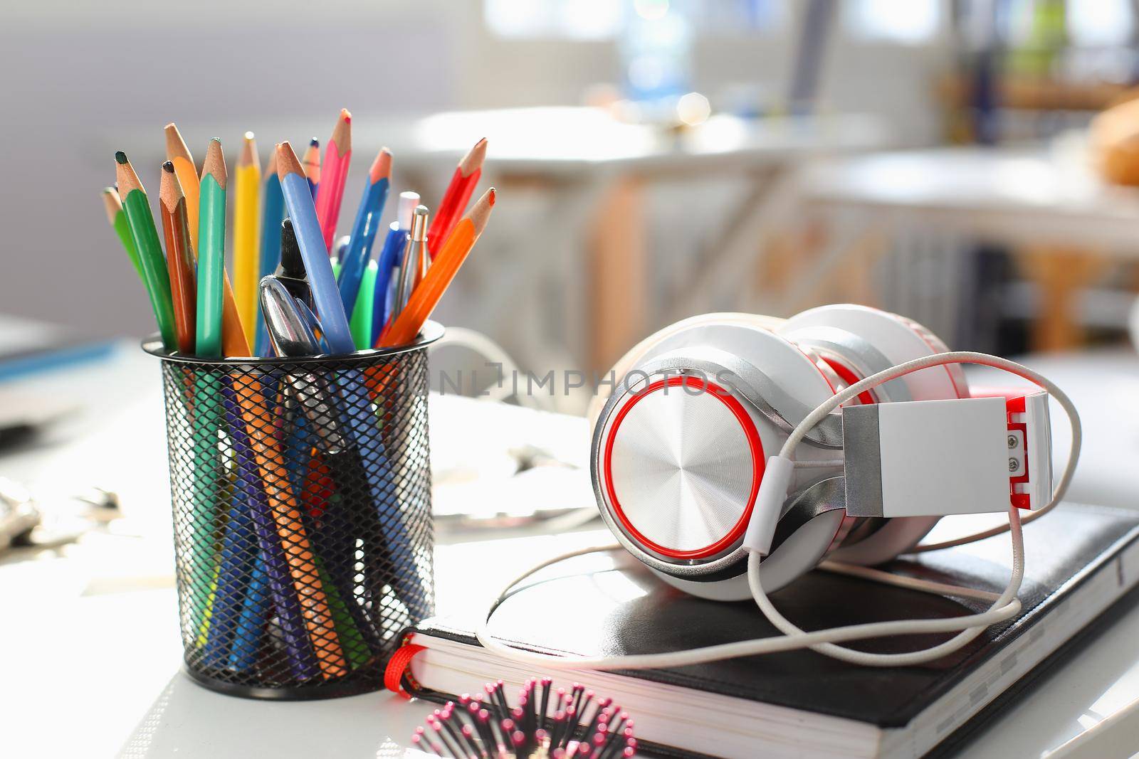 Headphones diary and pencil lie on the desk of the concept by kuprevich