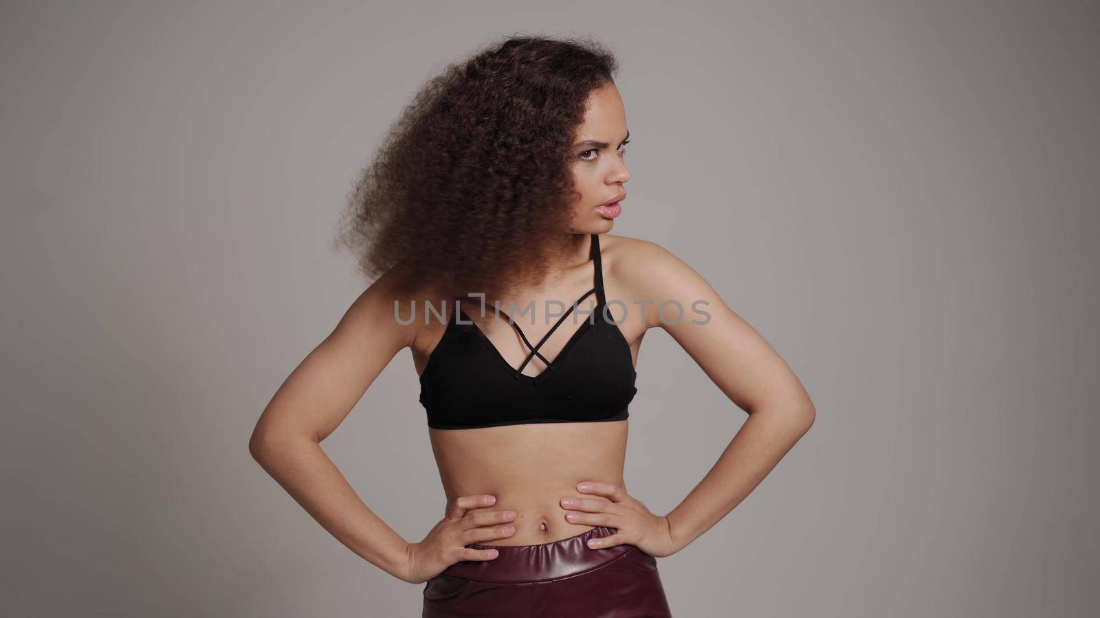 Denying, shields, stop and rejecting gesture African American young woman standing in black bare shoulder top isolated on grey background. Human emotions, facial expression concept.