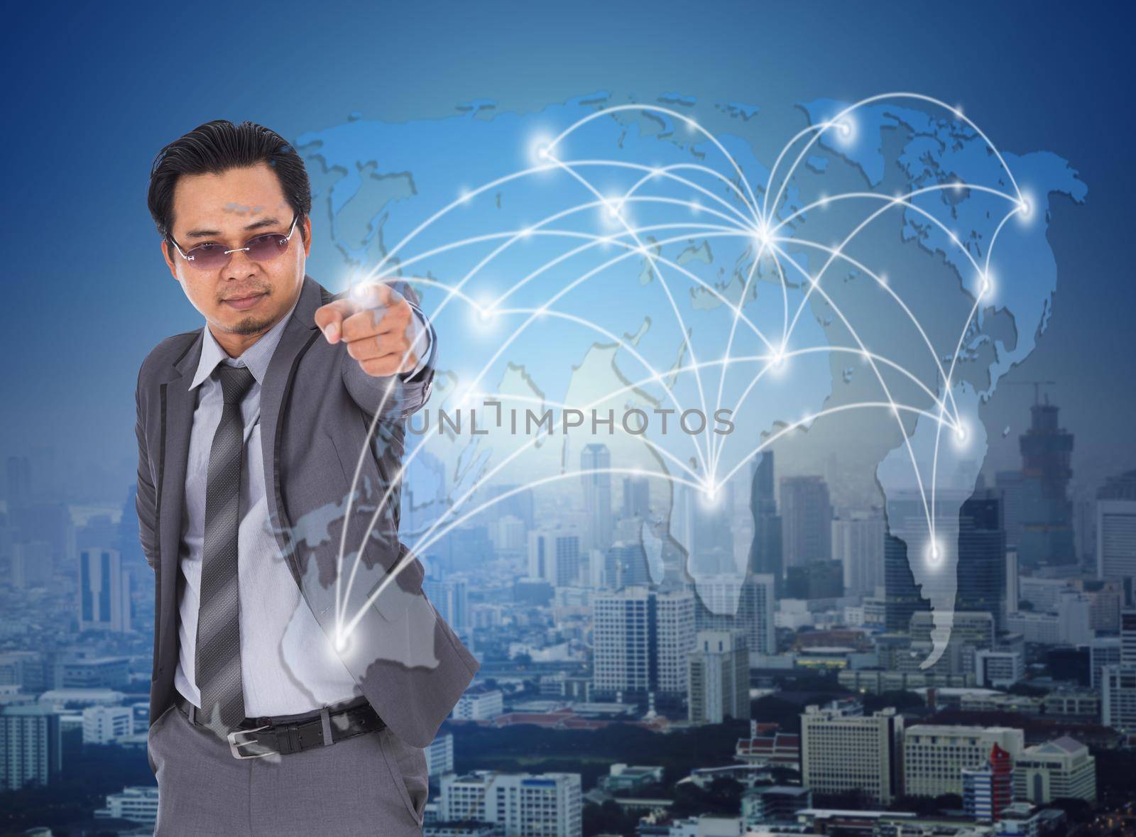 young business man pressing on world map network (vitual touchscreen)