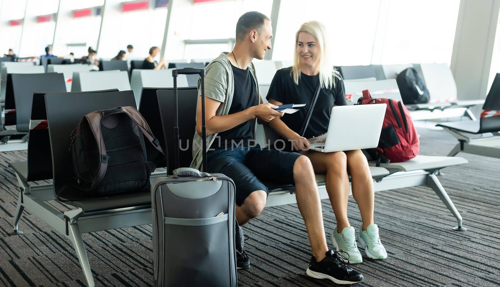 lovely couple with laptop at airport by Andelov13