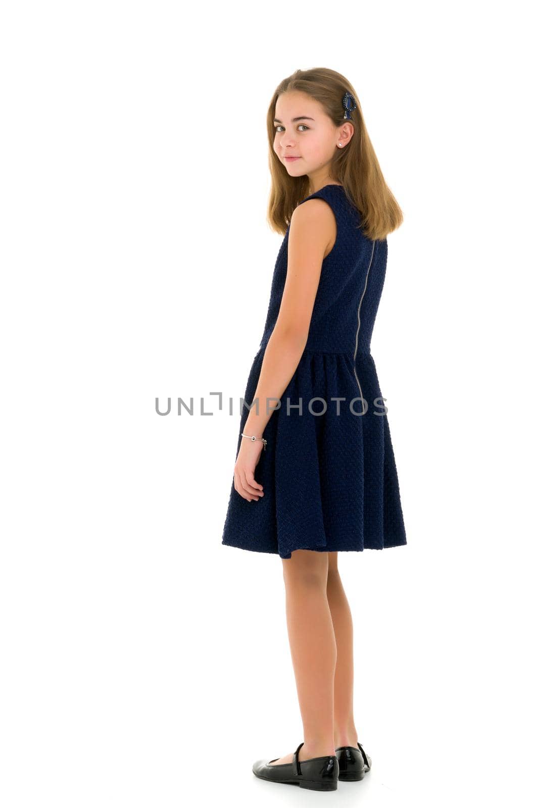 Beautiful little girl in an elegant dress in full growth. The concept of style and fashion. Layout for magazine cover. Isolated on white background.