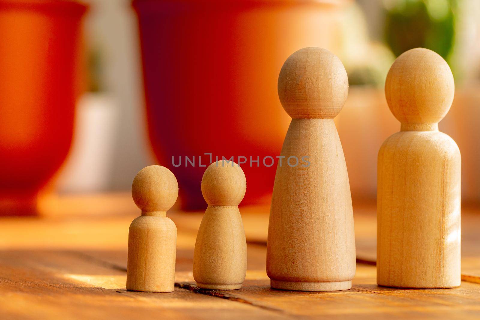 Small wooden figures of family members. Family relationship symbol by Fabrikasimf