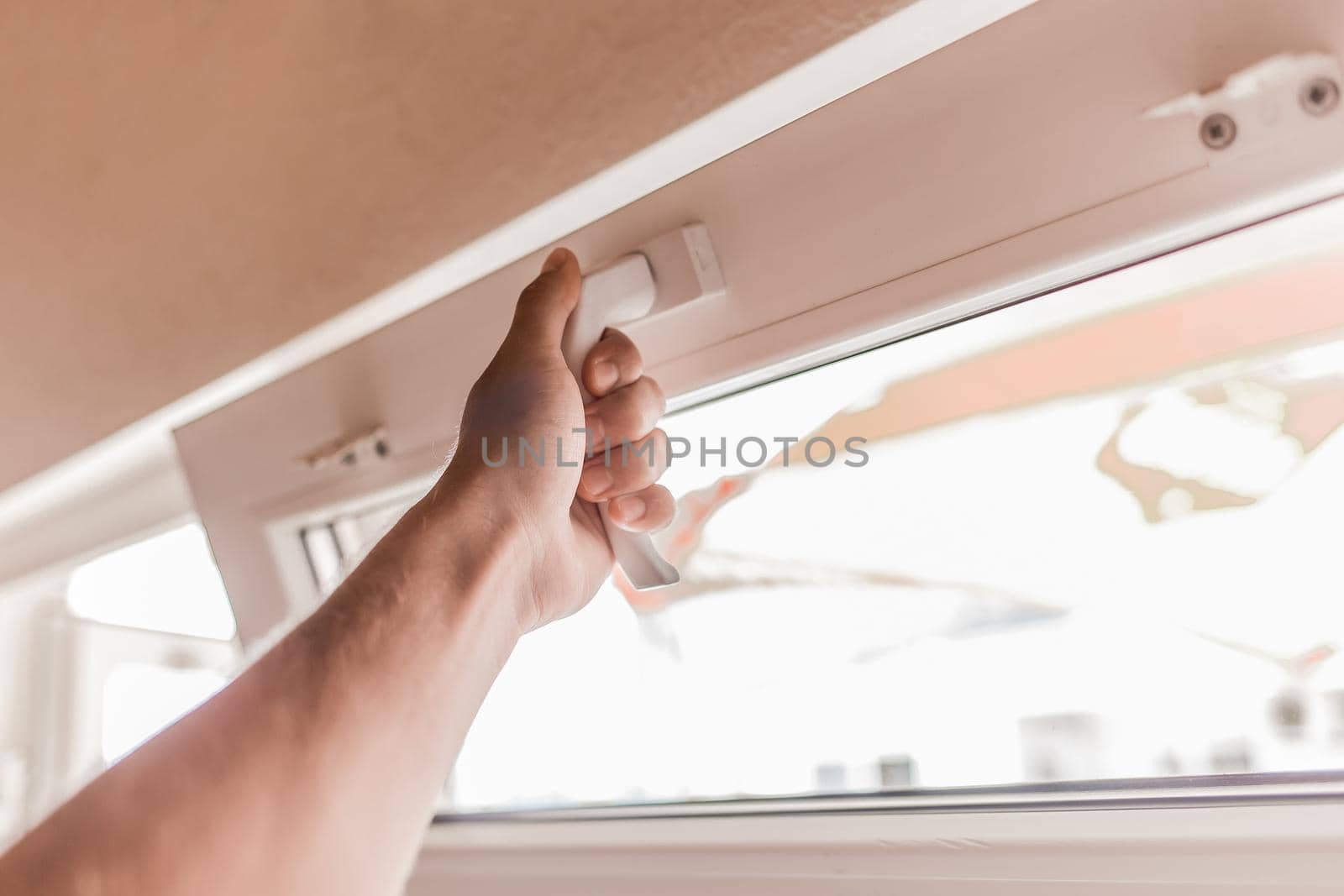 The guy's hand opens a plastic double window for the handle pvc double glazing by AYDO8