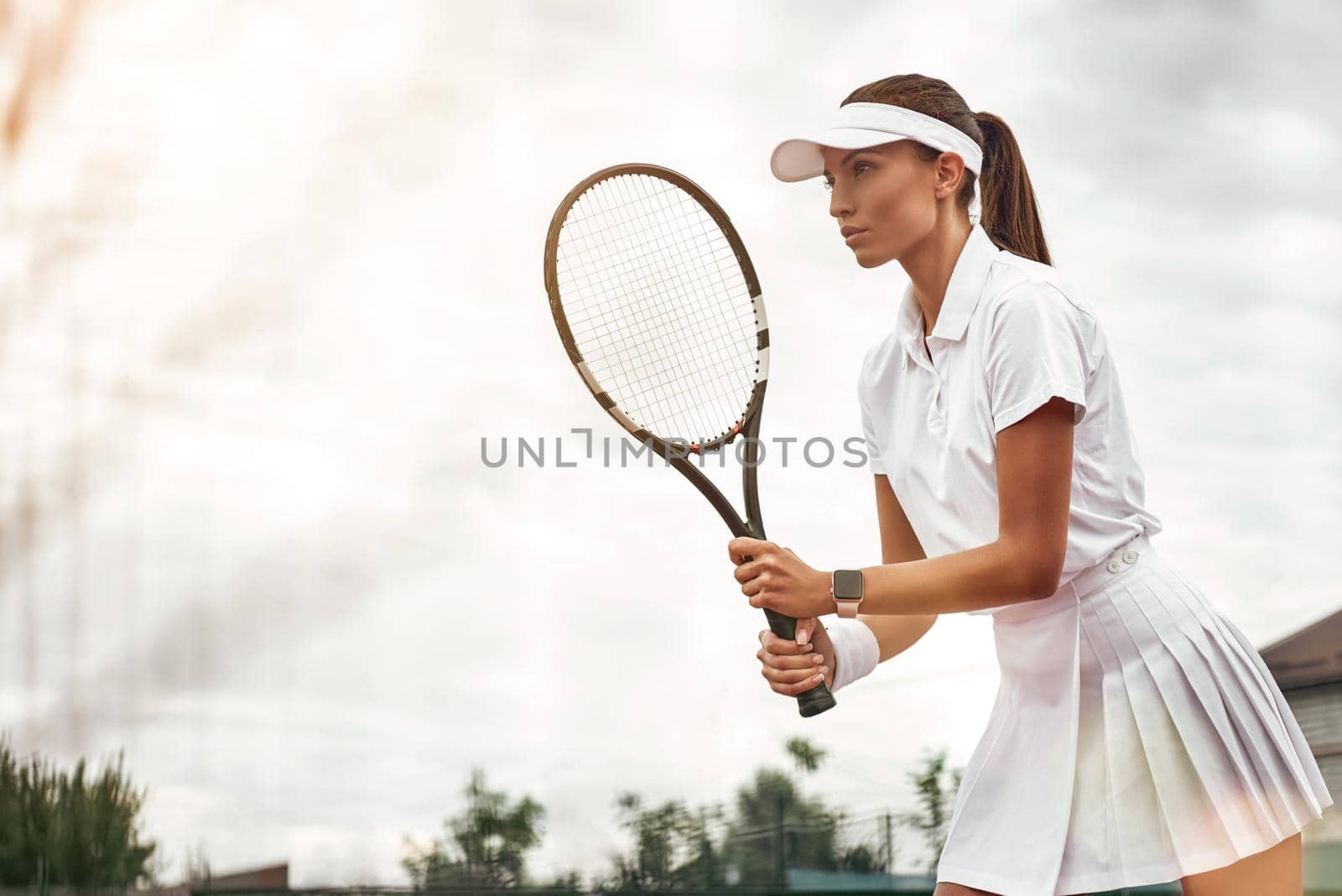 Woman playing tennis and waiting for the service by friendsstock