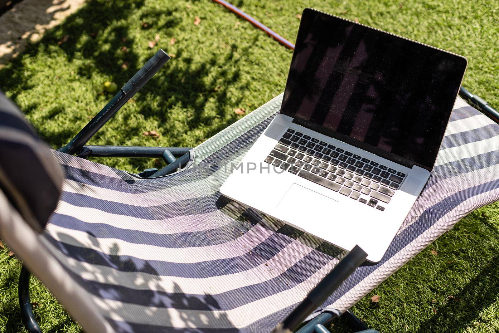 laptop on a sun lounger side view.