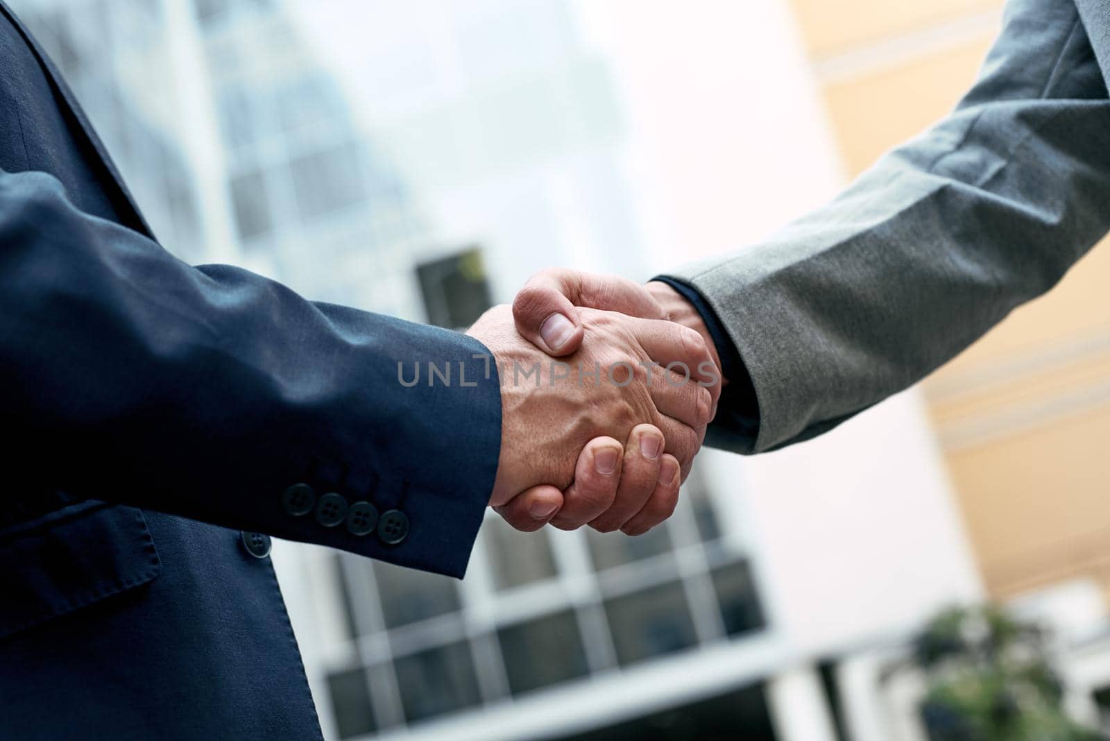Business people shaking hands, Greeting Deal Concept, modern city background