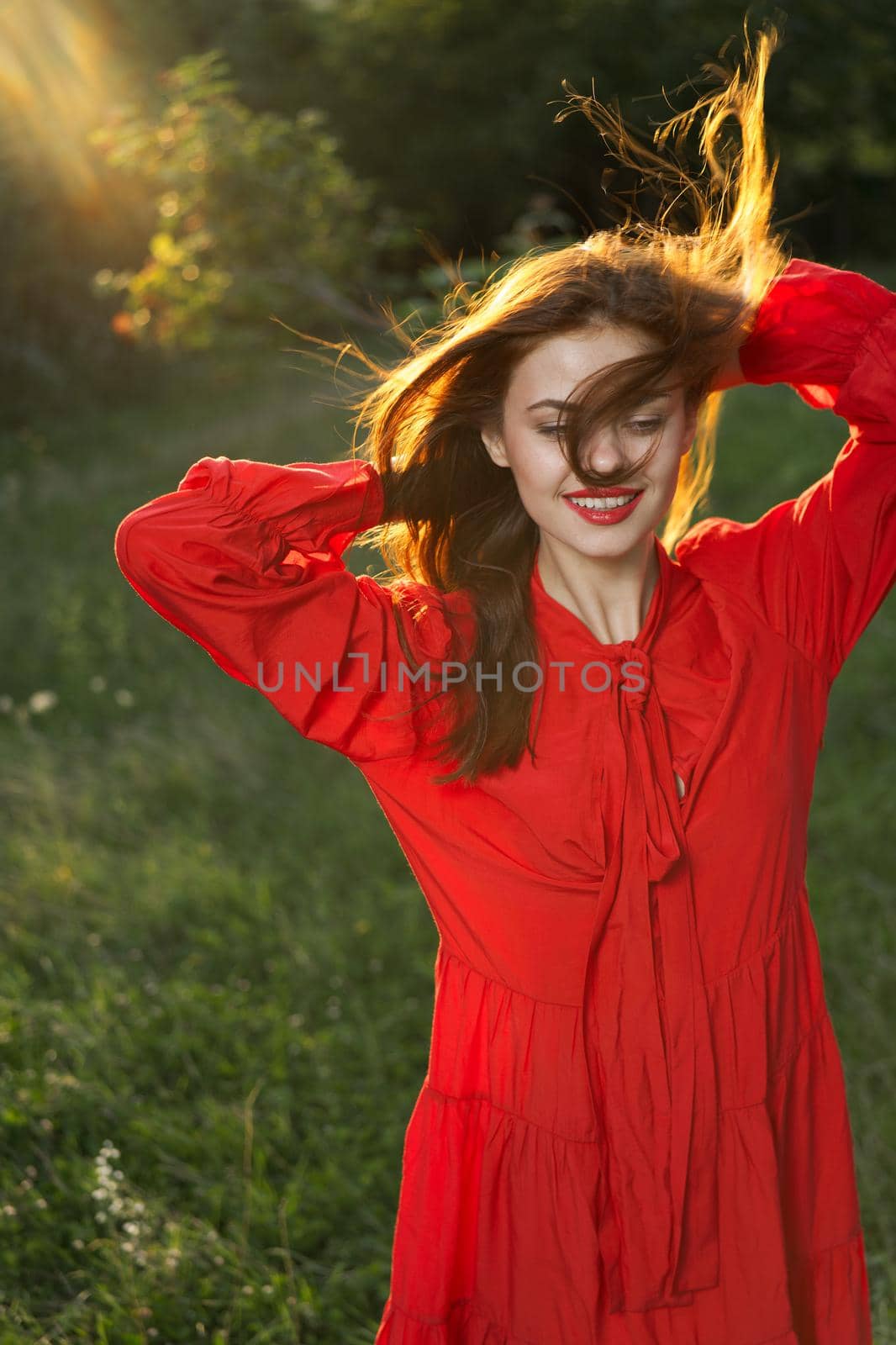 woman in red dress posing nature sun fun. High quality photo