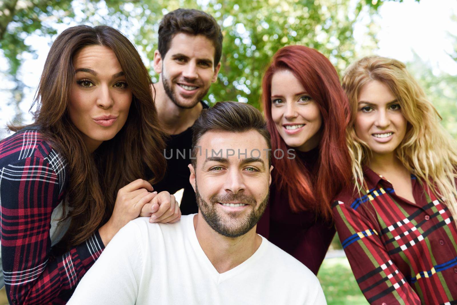 Group of young people together outdoors in urban background by javiindy