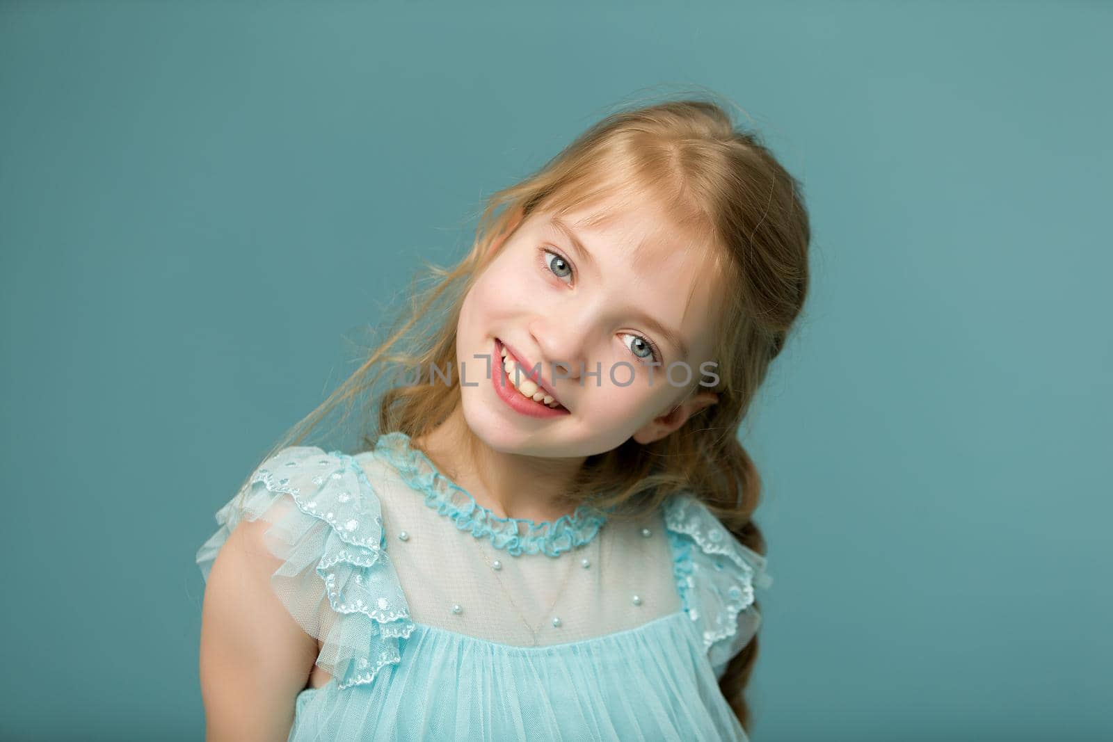 Beautiful little girl close-up. The concept of beauty and fashion, happy childhood.