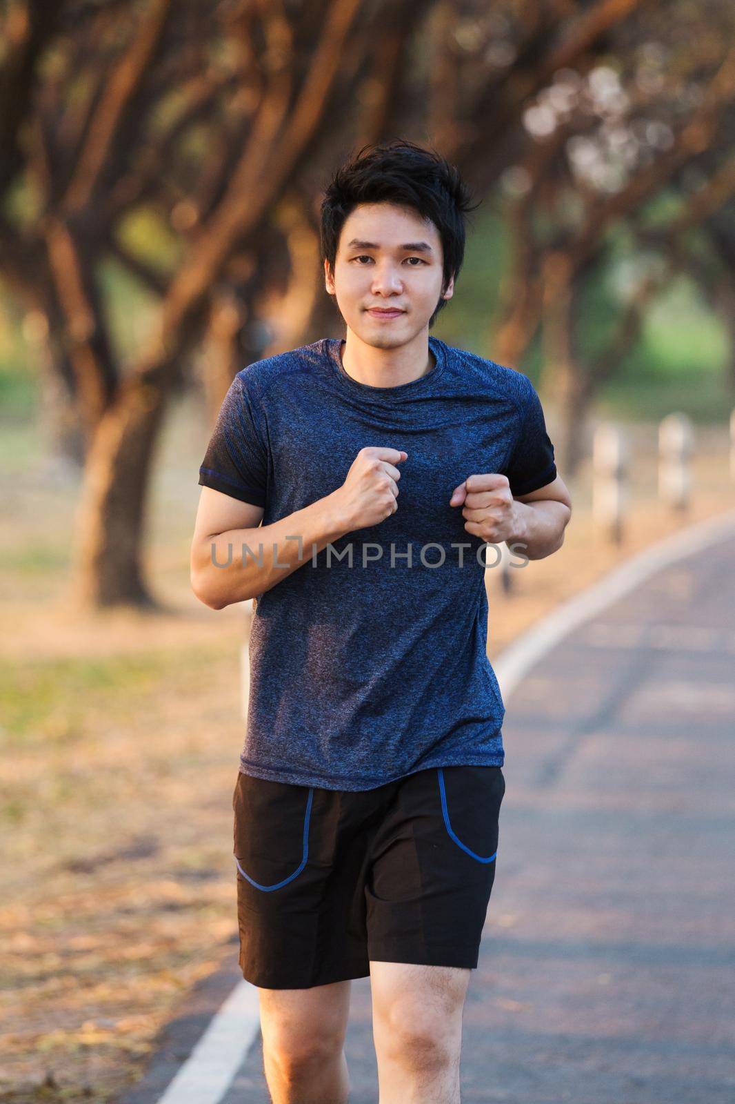 fitness man running in park by geargodz