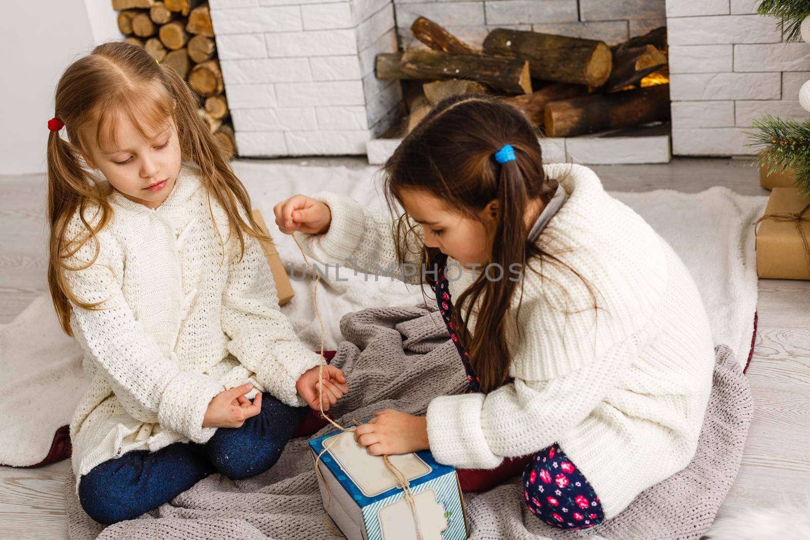 Two little girls in Christmas background.