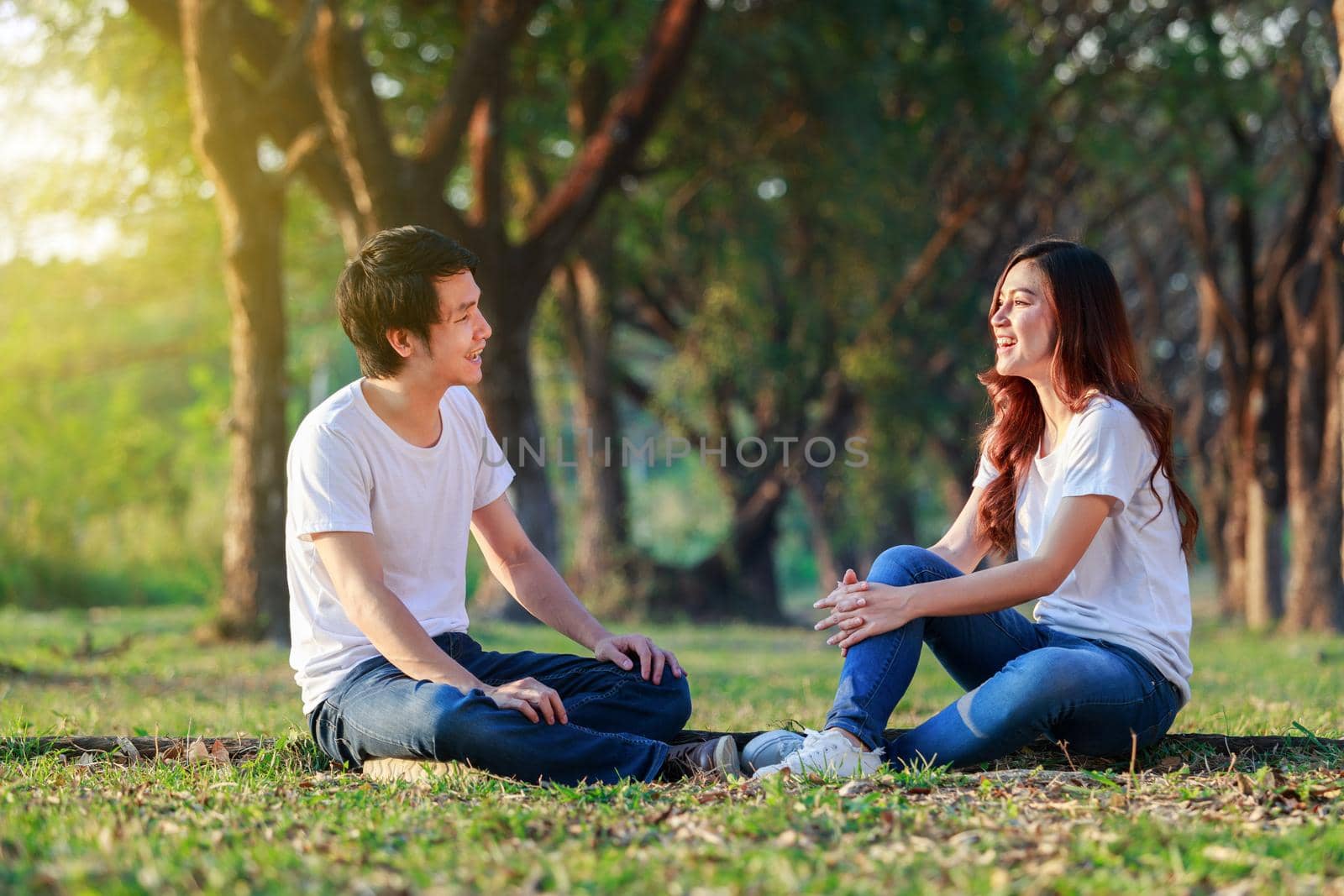 young couple talking and laghing in park by geargodz