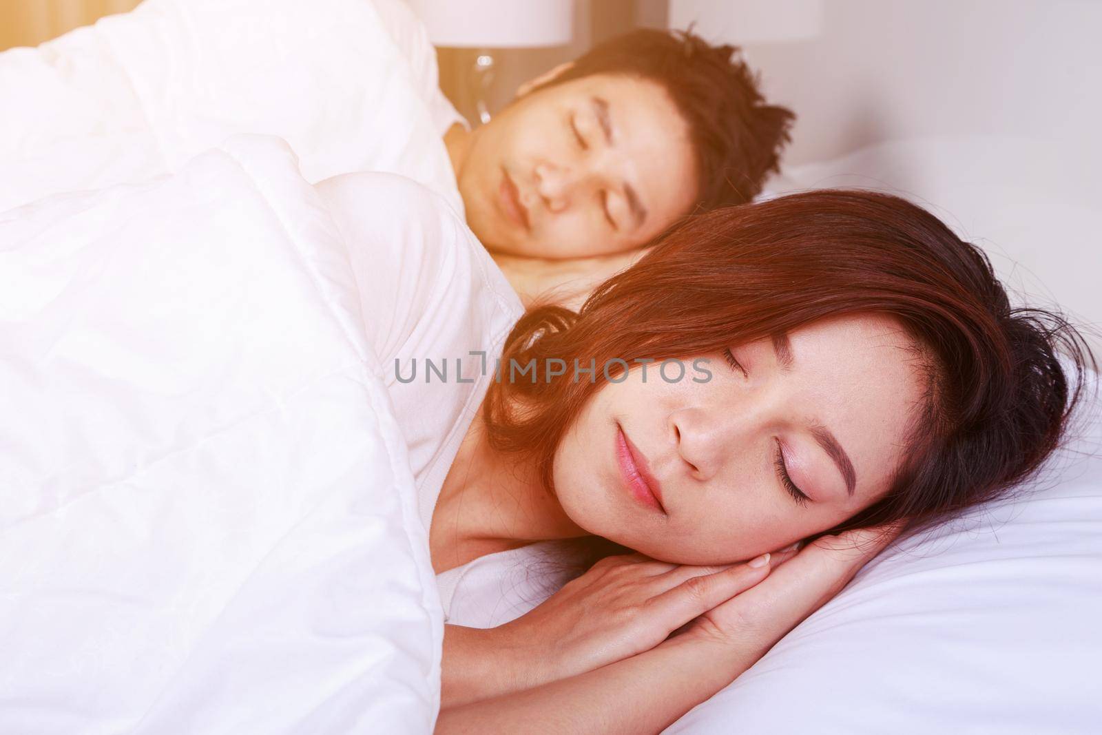 couple sleeping on a comfortable bed in bedroom at home by geargodz