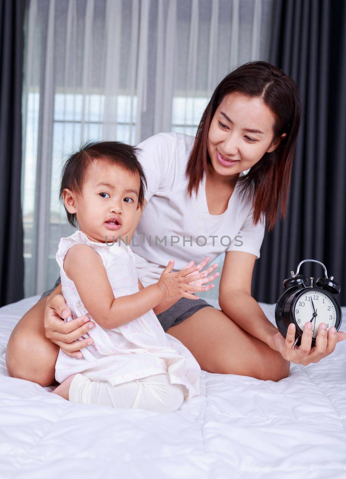 baby with mother on the bed at home