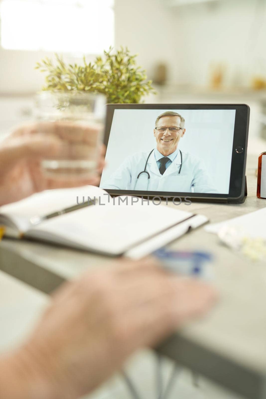 Friendly healthcare specialist on a tablet screen during video-counselling by friendsstock